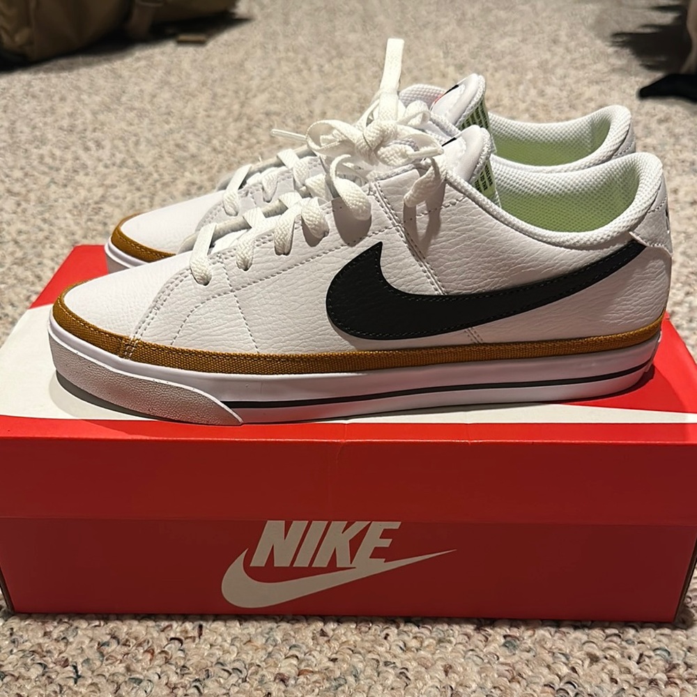 Nike White Sneakers with Black Swoosh and Gold Trim